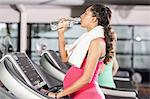 Pregnant woman drinking water at the leisure center