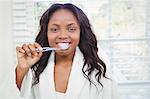 Beautiful woman about to brush her teeth in the bathroom