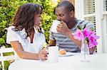 Ethnic couple having a mug of tea in the garden