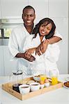 Ethnic couple having breakfast in the kitchen