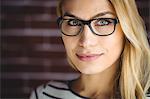 Portrait of beautiful blonde woman on brick wall