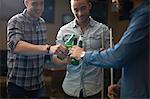 Men toasting with beer at pool club