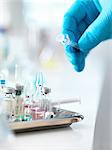 Doctor placing syringe back onto tray with drug vials