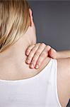 Cropped close up shot of young womans hand massaging her own shoulder