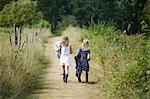 Girls walking on dirt road