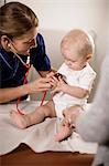 Doctor examining baby girl