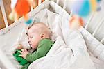 Baby sleeping in cot