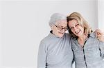 Portrait of senior woman holding hands with daughter