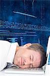 Businessman lying on laptop with his head