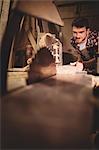 Carpenter working on his craft in a dusty workshop