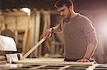 Carpenter working on his craft in a dusty workshop