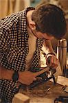 Carpenter working on his craft in a dusty workshop