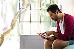 Man using digital tablet at home