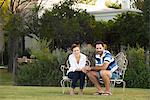 Couple relaxing together outdoors, portrait