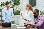 Businesswoman explaining idea to colleagues at meeting