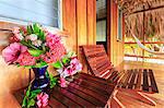Vacation cabin porch with tropical pink flowers, St. Georges Caye, Belize, Central America