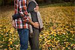 Cropped shot of mid adult couple hugging in autumn forest