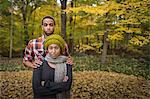 Portrait of mid adult couple standing in autumn forest