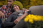 Romantic mid adult couple at dusk in autumn garden