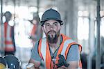 Builder taking a coffee break on construction site