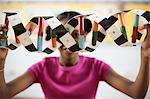 A girl in a science class holding a model of a helix structure in front of her face.