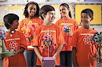 A group of girls and boys wearing the teeshirt of the Science Club, making molecular structure models.