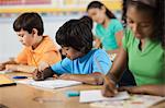 A group of young girls and boys in a classroom, classmates.