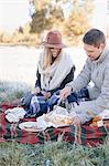 A couple sitting having a picnic.