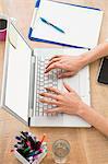 Casual businesswoman using laptop in the office