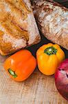 Table with fresh fruits vegetables and bread on a sunny day