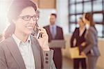 Businesswoman using her smartphone at the office