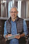 Happy brewer checking his product at the local brewery