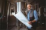 Local brewer standing in the plant at the local brewery