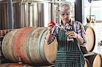 Happy brewer checking his produce at the local brewery