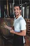 Winemaker taking notes on clipboard on winefarm