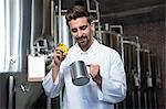 Focused brewer testing his beer at the microbrewery