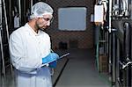 Focused brewer working in the plant in a brewery factory