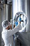 Focused brewer working in the plant at the local brewery