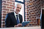 Businessman using tablet in a pub