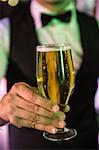 Close-up of bartender serving glass of beer at bar counter in bar