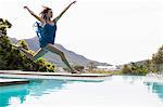 Elegant woman diving in the pool on a summers day