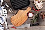 Cooking utensils and spices on wooden table. Top view