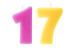 Colorful birthday candles in the form of the number seventeen on white background