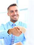 businessman shaking hands to seal a deal with his partner