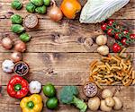 Fresh and healthy organic vegetables and food ingredients on wooden background