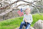little american boy holding american flag celebrating 4th of july/independence day