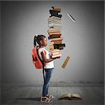 Child with backpack and a books pile
