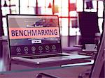 Benchmarking Concept Closeup on Laptop Screen in Modern Office Workplace. Toned Image with Selective Focus. 3d Render.