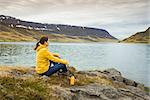 Beautiful woman resting close to a beautiful lake