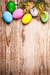 Easter eggs with bunch mimosa copyspace on wooden board